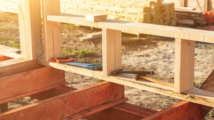 Manual tools on wooden plank at cottage construction site