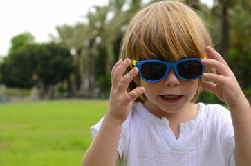 Portrait of a little boy. Child 3 years old, boy with long hair. place for text. Emotions on the face