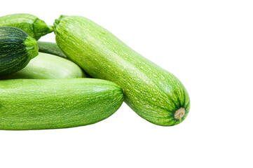 fresh zucchini on a white background. delicious green vegetables on the table. appetizing zucchini on a light texture. healthy food concept