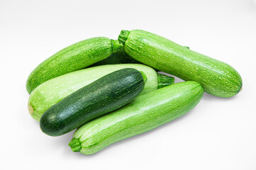 fresh zucchini on a white background. delicious green vegetables on the table. appetizing zucchini on a light texture. healthy food concept