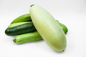 fresh zucchini on a white background. delicious green vegetables on the table. appetizing zucchini on a light texture. healthy food concept