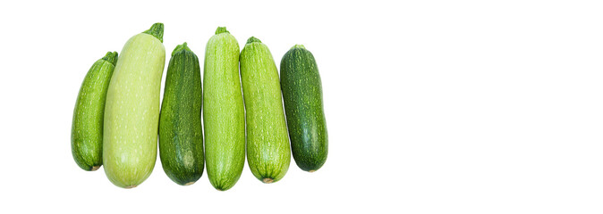 fresh zucchini on a white background. delicious green vegetables on the table. appetizing zucchini on a light texture. healthy food concept