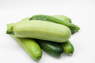 fresh zucchini on a white background. delicious green vegetables on the table. appetizing zucchini on a light texture. healthy food concept
