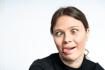 Happy Young woman making funny faces, wearing black