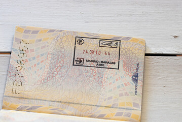 Entry visa to Spain, Madrid Barajas airport on a white wooden table as a background