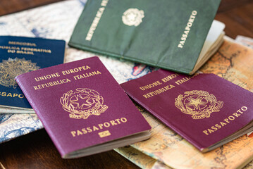 Brazilian and Italian passports on an ancient map of South America ready for the tour. Holidays concept.