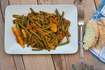 green beans, onion and potatoes stewed in tomato, herbs and olive oil, fasolakia ladera in Greece