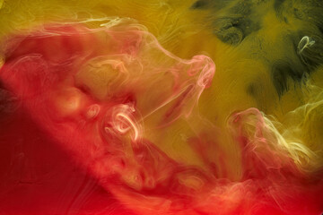 Liquid fluid art abstract background. Red, yellow dancing acrylic paints underwater, space smoke ocean, color explosion