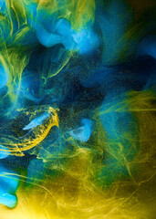 Liquid fluid art abstract background. Blue yellow dancing acrylic paints underwater, ocean space smoke