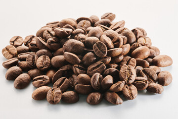 Roasted coffee beans isolated close up on white background, clipping path