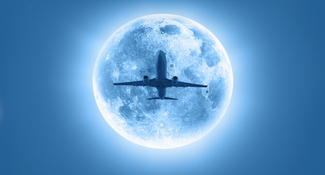 Silhouette of a passenger plane passing in front of the full moon "Elements of this image furnished by NASA "