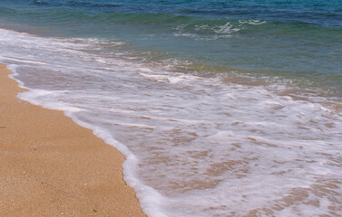 Clear emerald green sea with clean sandy beach
