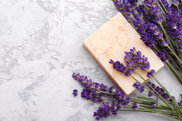 Obraz na płótnie Canvas Hand made soap with lavender flowers on the grey stone background flat lay with copy space