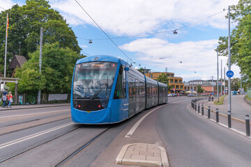 Plakat Tram passing the ABBA museum and Tivoli platform on the way to the central station T Centralen, a sunny summer day in Stockholm