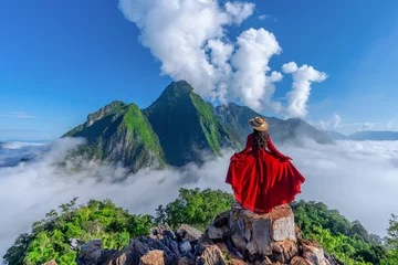 Fotobehang Asian girl on top of Viewpoint of Nong Khiaw - a secret village in Laos. Stunning scenery of limestone cliff valley covered with fog. © chanchai