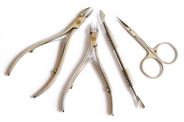 Cuticle pusher, cuticle trimmer. nail trimmer and purpose scissors isolated on a white background. Manicure and pedicure nail care tools set. Top view.