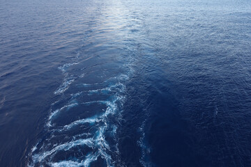 Frothy trail behind the boat on the ocean..