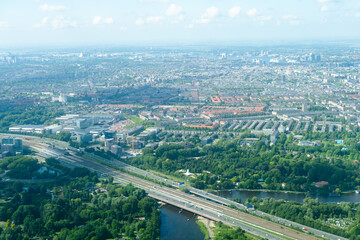 Aerial view from airplane of modern city with buildings, skyscrapers and highways between river. Amsterdam, Holland 