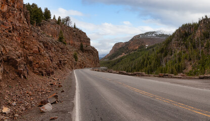 Scenic Road in the American Landscape. Yellowstone National Park, Wyoming. Cloudy Sky Art Render. United States. Nature Background Panorama