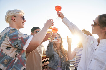 Group of friends make a toast in summer day
