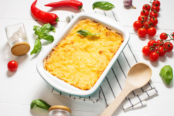 Delicious homemade italian Lasagna with bachamel sauce in the oven in a ceramic dish.