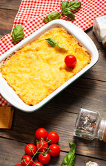 Delicious homemade italian Lasagna with bachamel sauce in the oven in a ceramic dish. rustic, top view