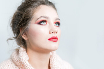 Portrait of a beautiful girl with bright red make-up close-up.