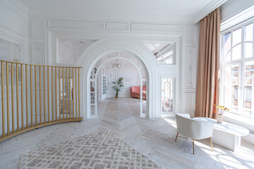 snow-white luxury apartment interior with Egyptian-style decor with light stylish furniture. huge panoramic windows and an archway. minimalism and simplicity with the elegance of modern housing design