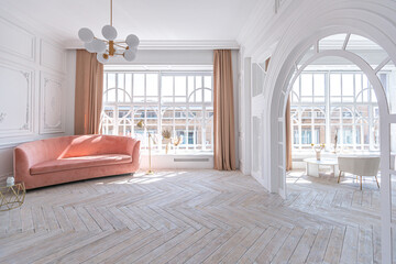 snow-white luxury apartment interior with Egyptian-style decor with light stylish furniture. huge panoramic windows and an archway. minimalism and simplicity with the elegance of modern housing design