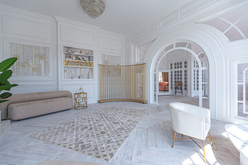 snow-white luxury apartment interior with Egyptian-style decor with light stylish furniture. huge panoramic windows and an archway. minimalism and simplicity with the elegance of modern housing design