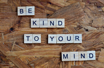 be kind to your mind text on wooden square, motivation quotes
