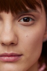 close vertical photo of a young woman with clean, well-groomed skin looking into the camera