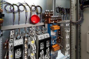 Closeup shot of an electrical switchboard with wires and fuses