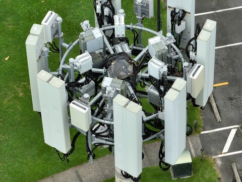 Overhead Shot Of A Phone Tower Over The Green Grass