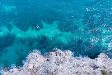 Aerial view of waves splashing on beach.