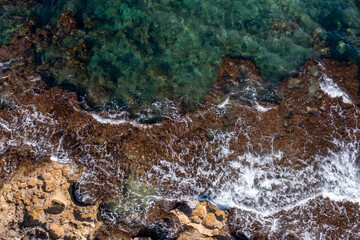 Aerial view of waves splashing on beach