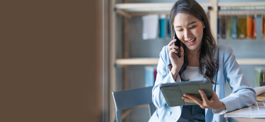 smart business owner asian female startup entrepreneur small business manager businesswoman wear smart casual cloth smile hand use tablet smartphone working inventory checking in showroom studio