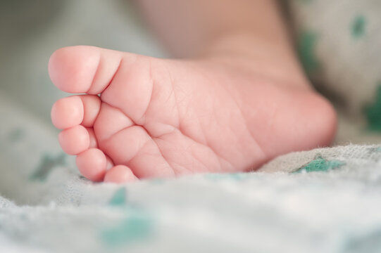 Close-up detail abstract macro view of cute baby small leg foot finger010 . Soft child skin feet. Love and family emotion