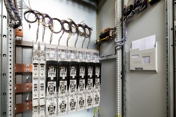 Electrical wires, switchboard, and fuses hanging on the wall