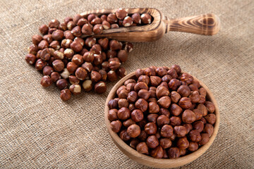 View of a bowl full of hazelnuts on burlap
