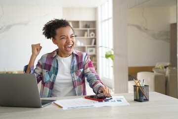 Remote study at home. Exam is passed successfully. Excellent teenage girl celebrating her victory.