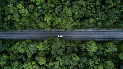 Aerial view green forest and asphalt road, Top view forest road going through forest with car...