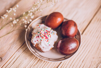Easter table with traditional Easter cakes and Easter eggs with blossoming tree branch