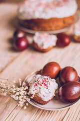 Easter table with traditional Easter cakes and Easter eggs with blossoming tree branch