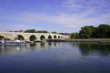 Fototapeta na wymiar Stone Bridge Regensburg, seen from the south bank of the Danube.