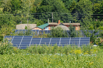 Solar panels set near a rustic house.