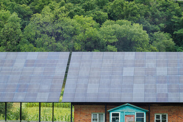 Solar panels are installed on the roof of a village house.