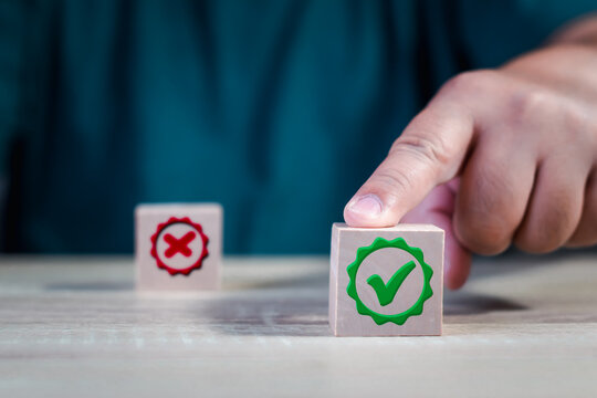 Hand finger point a choice between two cubes with right and wrong