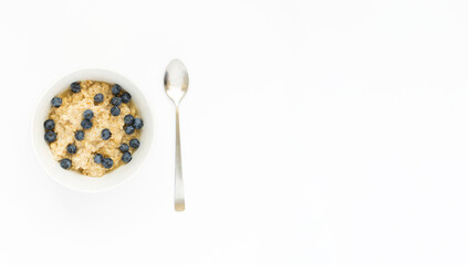 A bowl of oatmeal with blueberries on a white banner with space for text. English breakfast . Healthy food concept.