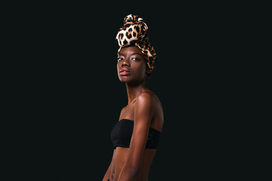 Side of confident black girl wear african turban